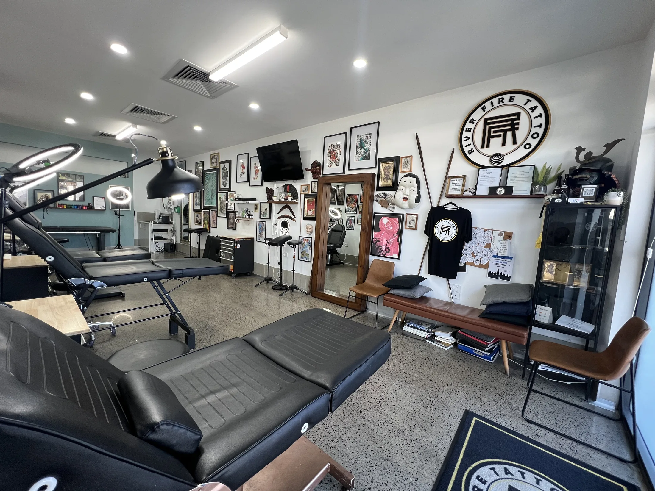 River Fire Tattoo studio in Wyee, photographed from the front-right with the tattoo bays lit