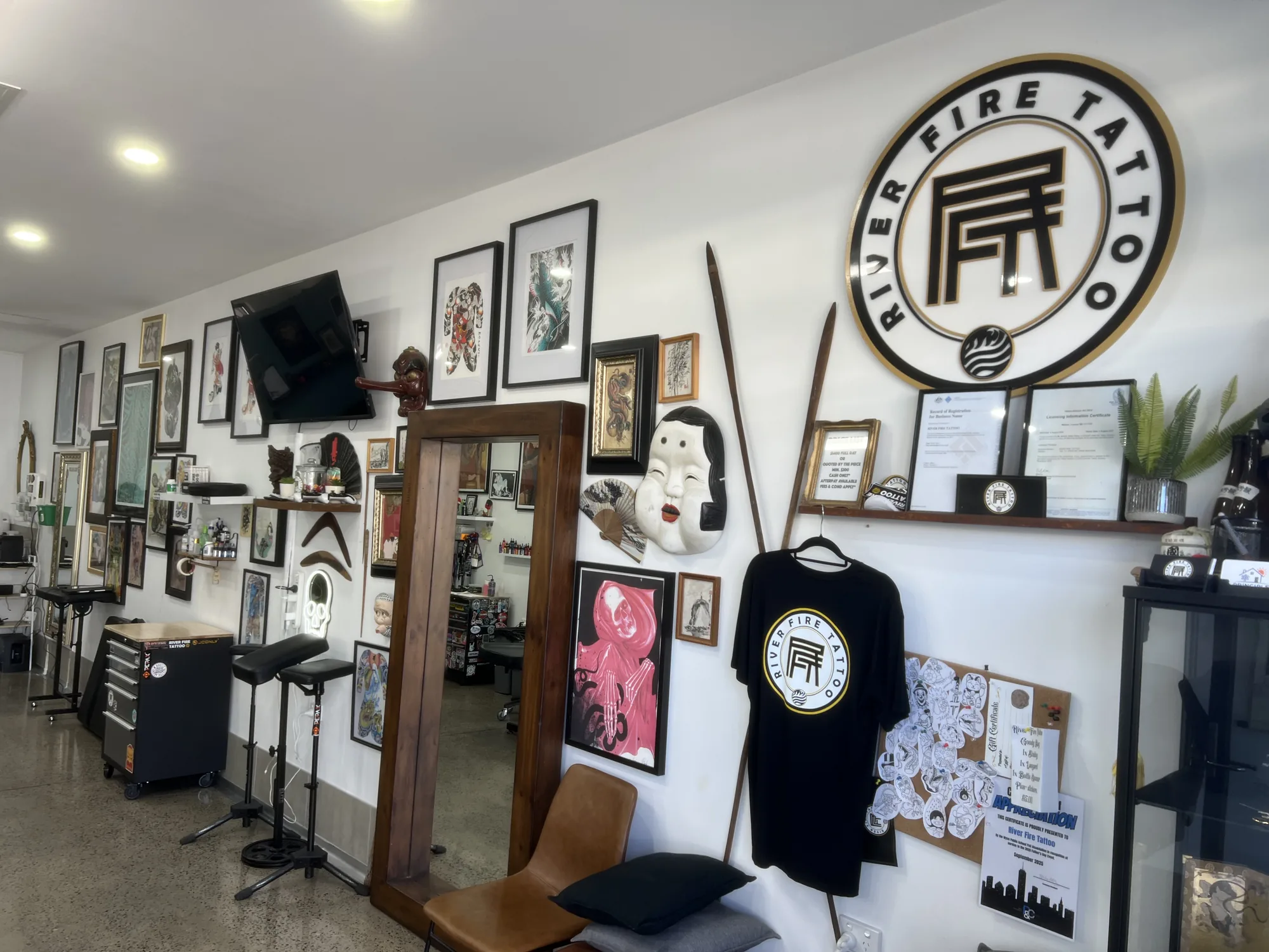 Circular River Fire Tattoo wall sign above the waiting bench