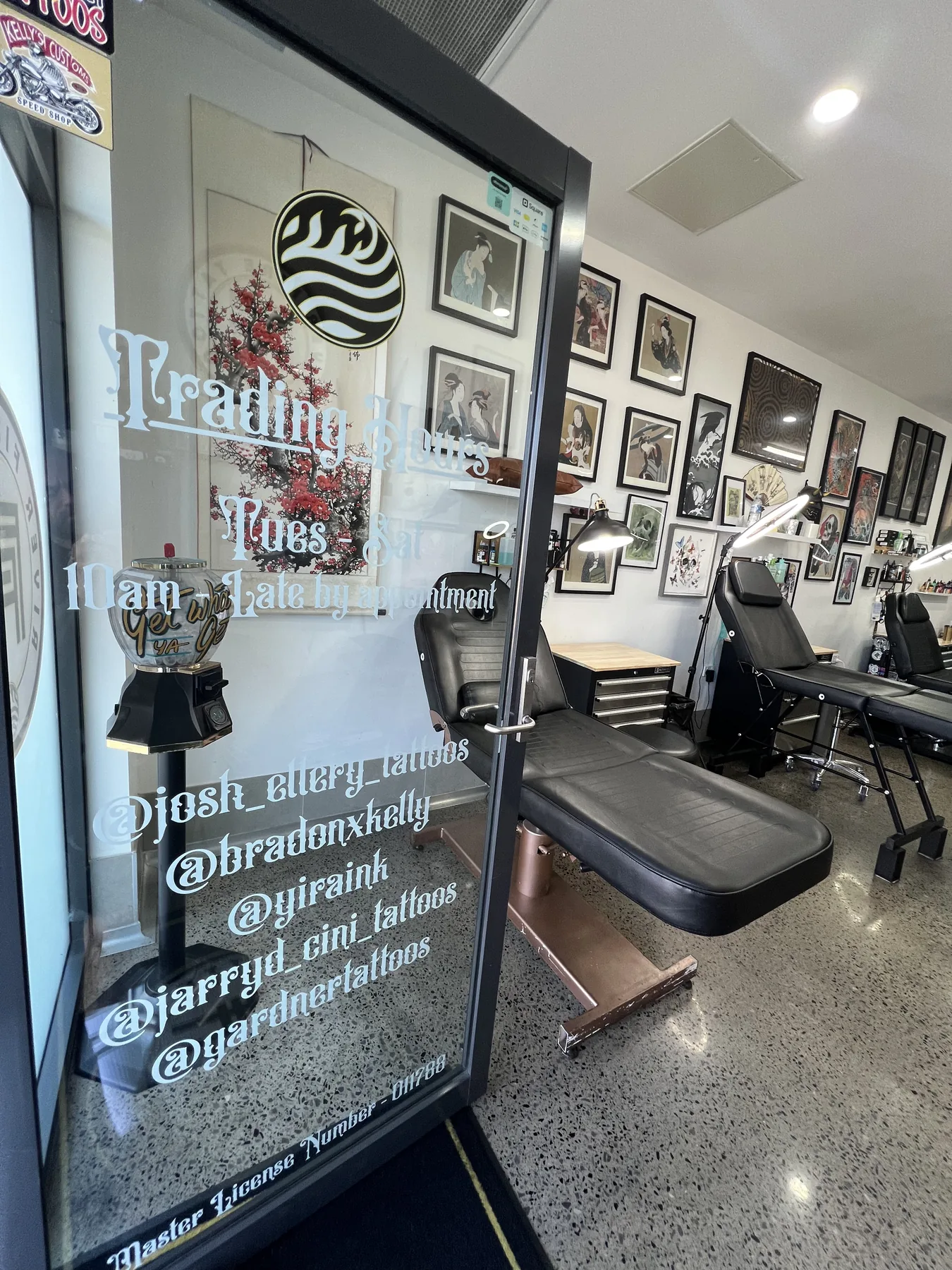 River Fire Tattoo entrance, with trading hours and artist Instagram handles on the glass door