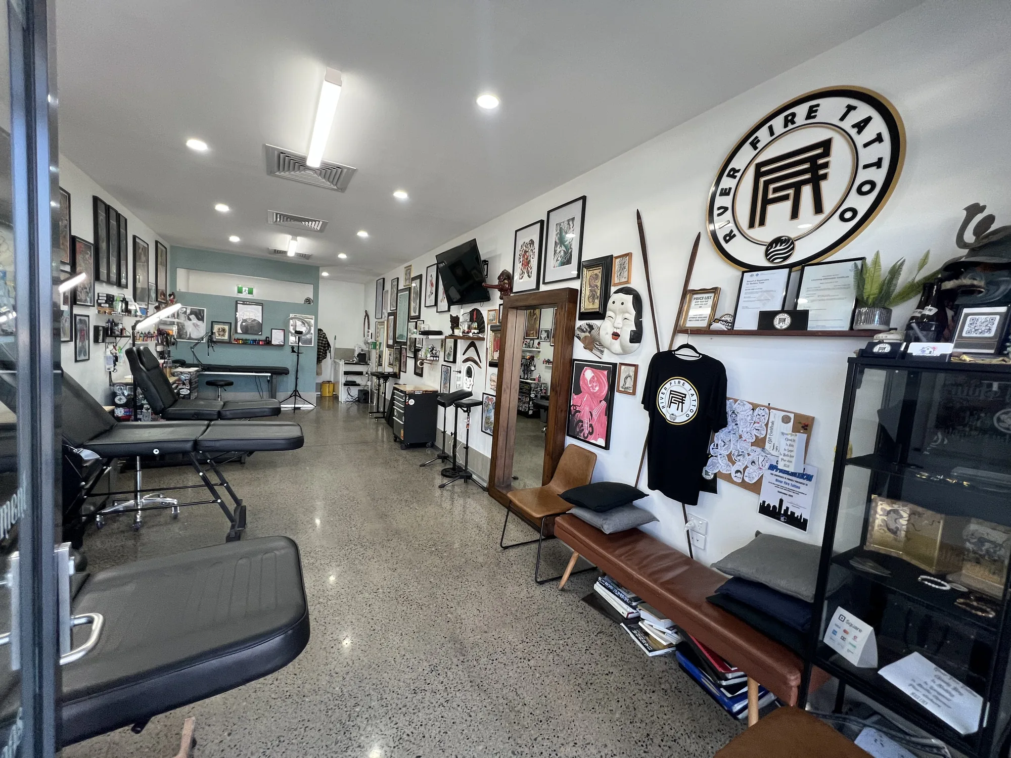 River Fire Tattoo studio from the front-left corner, looking down the shop